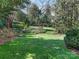 Expansive backyard featuring well-manicured lawns, mature trees, and tranquil garden spaces at 1136 Bolling Rd, Charlotte, NC 28207