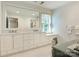 Bright bathroom featuring a large mirror, double vanity, and classic patterned wallpaper at 1136 Bolling Rd, Charlotte, NC 28207