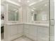 Bright bathroom featuring a double sink vanity with white countertops, ample storage, and hexagon tile flooring at 1136 Bolling Rd, Charlotte, NC 28207