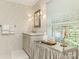 Bathroom featuring patterned wallpaper, a white vanity with mirror, and a unique makeup table with a mirror top at 1136 Bolling Rd, Charlotte, NC 28207