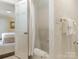 Open door view of a bathtub with shower, with the bedroom visible at 1136 Bolling Rd, Charlotte, NC 28207