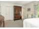 Bright bedroom featuring a large wardrobe, comfortable seating, and serene decor at 1136 Bolling Rd, Charlotte, NC 28207