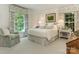 Tranquil bedroom with floral curtains, large windows, and comfortable furnishings at 1136 Bolling Rd, Charlotte, NC 28207