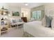 Bright bedroom featuring a sitting area, textured wallpaper, and a large window for ample natural light at 1136 Bolling Rd, Charlotte, NC 28207