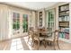 Sunlit dining room featuring French doors, complemented by tasteful decor and comfortable seating arrangements at 1136 Bolling Rd, Charlotte, NC 28207