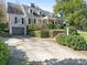 Elegant brick home showcasing a two-car garage, brick walkway, and lush landscaping at 1136 Bolling Rd, Charlotte, NC 28207