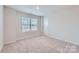 Clean bedroom featuring carpet flooring, a large window, and a door at 1175 Blackburn Cir, Edgemoor, SC 29712