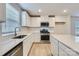 Bright kitchen features stainless steel appliances, white cabinets, and a light countertop at 1175 Blackburn Cir, Edgemoor, SC 29712