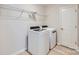 Laundry room featuring modern white washer and dryer appliances and a storage shelf at 1175 Blackburn Cir, Edgemoor, SC 29712