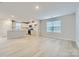 Open-concept living room with modern flooring, neutral paint, lots of natural light, and a view of the kitchen at 1175 Blackburn Cir, Edgemoor, SC 29712