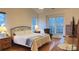 Main bedroom with hardwood floors and large windows at 12111 Frogs Leap Ct, Charlotte, NC 28277