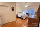 Main bedroom with hardwood floors and large windows at 12111 Frogs Leap Ct, Charlotte, NC 28277