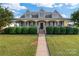 Two-story house with wrap-around porch, stone accents and manicured lawn at 1265 Maddy Ln, Rock Hill, SC 29732