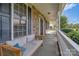 Relaxing front porch with stone accents, white railings, and comfortable seating at 1265 Maddy Ln, Rock Hill, SC 29732