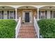 Brick steps leading to a front porch with stone accents and white railings at 1265 Maddy Ln, Rock Hill, SC 29732