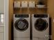 Modern laundry room with washer, dryer, and shelving at 13131 Hampton Bay Ln, Charlotte, NC 28262