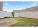 Backyard with white fence, small patio, and partial shade at 135 Singleton Rd, Mooresville, NC 28117