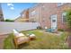 Private backyard with a white fence, patio seating, and green lawn at 135 Singleton Rd, Mooresville, NC 28117