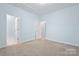 Bright bedroom with carpeted floors, walk-in closet, and an ensuite bathroom at 135 Singleton Rd, Mooresville, NC 28117