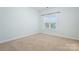 Bright bedroom featuring neutral carpet and pale blue walls and a window at 135 Singleton Rd, Mooresville, NC 28117