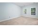 Carpeted bedroom with two windows and light blue walls at 135 Singleton Rd, Mooresville, NC 28117