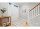 Inviting entryway with hardwood floors, staircase, and a decorative table at 135 Singleton Rd, Mooresville, NC 28117