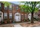 Brick townhome featuring a front entrance, porch, and sidewalk at 135 Singleton Rd, Mooresville, NC 28117