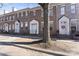 A row of brick townhomes with white trim and entrance features, enhancing curb appeal on a sunny day at 135 Singleton Rd, Mooresville, NC 28117