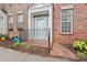 Charming brick townhome showcasing a welcoming front entrance and a well-manicured walkway at 135 Singleton Rd, Mooresville, NC 28117