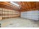 Spacious garage with exposed wooden beams, open shelving, and ample room for parking and storage at 135 Singleton Rd, Mooresville, NC 28117