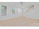 Inviting living room with neutral walls, light wood floors, and a view of the staircase at 135 Singleton Rd, Mooresville, NC 28117