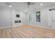 Open-concept living room showcasing a modern fireplace and light wood floors at 135 Singleton Rd, Mooresville, NC 28117