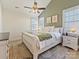 Bright and airy bedroom with a sleigh bed, accent wall, and ceiling fan at 13713 Batemans Rd, Huntersville, NC 28078