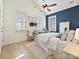 Bright bedroom with blue accent wall and built-in shelving at 13713 Batemans Rd, Huntersville, NC 28078