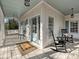 Inviting front porch with rocking chairs and a view of the yard at 13713 Batemans Rd, Huntersville, NC 28078