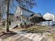 Charming two-story home with a front porch, American flag, and landscaped yard at 13713 Batemans Rd, Huntersville, NC 28078