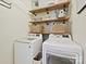 Laundry room with modern washer and dryer and wooden shelves at 13713 Batemans Rd, Huntersville, NC 28078