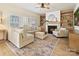 Light and airy living room with a sectional sofa, built-in shelving and fireplace at 13713 Batemans Rd, Huntersville, NC 28078