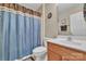 Standard bathroom features a shower with blue curtain, toilet, sink with wood vanity and a mirror at 153 Snead Rd # 72, Fort Mill, SC 29715