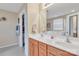 Bathroom featuring double sinks, wood cabinets, large mirror, and access to walk-in closet at 153 Snead Rd # 72, Fort Mill, SC 29715