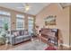 Bright living room featuring large windows, hardwood floors, a ceiling fan, plants, and piano at 153 Snead Rd # 72, Fort Mill, SC 29715