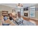 Cozy living room with a stone fireplace, wood floors, comfortable seating, and bright natural light at 153 Snead Rd # 72, Fort Mill, SC 29715