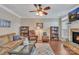 Inviting living room featuring a ceiling fan, hardwood floors, a fireplace, and built-in bookshelves at 153 Snead Rd # 72, Fort Mill, SC 29715