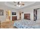 Carpeted main bedroom featuring tray ceiling, en suite bath access and a view of organized closet at 153 Snead Rd # 72, Fort Mill, SC 29715