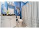 Clean bathroom with blue walls, white vanity, and a shower/tub combo at 172 Longleaf Dr, Mooresville, NC 28117