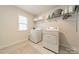 Bright laundry room with washer, dryer, and ample shelving at 172 Longleaf Dr, Mooresville, NC 28117