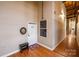 Apartment entry with wood floors and a small bench at 201 S Hoskins Rd # 313, Charlotte, NC 28208