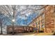 Brick building exterior with trees and landscaping at 201 S Hoskins Rd # 313, Charlotte, NC 28208