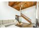 Living room with high ceilings, exposed beams, and loft access at 201 S Hoskins Rd # 313, Charlotte, NC 28208