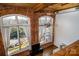 High-ceilinged living room with exposed brick and large windows at 201 S Hoskins Rd # 313, Charlotte, NC 28208